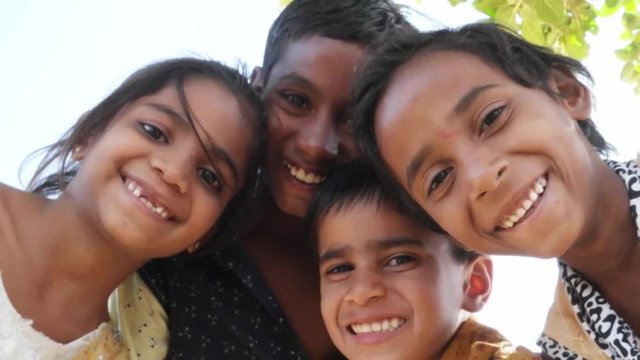 Indian children portrait happy and excited, playing and making merry in sand area in Rajasthan state of India 