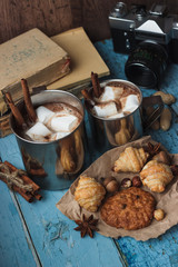 Metal mugs with cacao and marshmallows