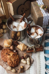 Metal mugs with cacao and marshmallows
