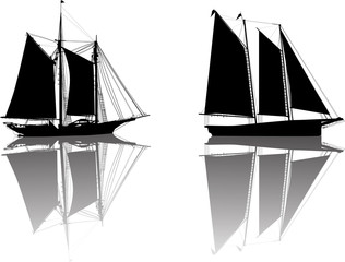 two black boats with sails and reflections