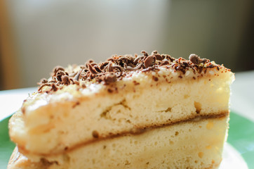 a piece of homemade biscuit cakewith chocolate sprinkles closeup