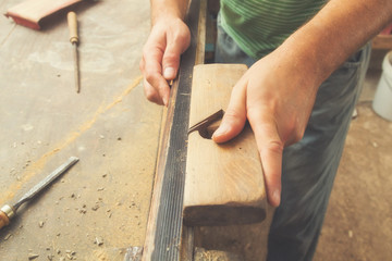 Carpenter working on raw wood.
