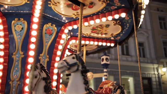 illuminated carousel in old city at night