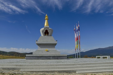  View of  Buddhist stupa Sofia in the Retreat Center Plana - Diamondway Buddhism Bulgaria near by Vitosha, Rila, Pirin, and Balkan mountains  from  distance  