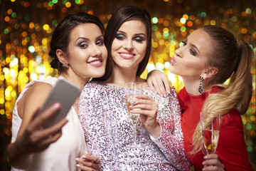 Girls taking selfie at the party