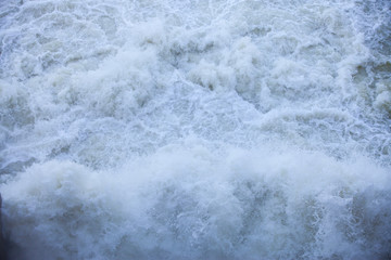 Water flowing from the open sluice gates of dam.