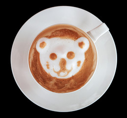 Cup of art latte or cappuccino coffee isolated on black.