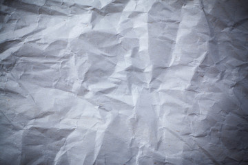 Recycled crumpled gray paper background dark edged.