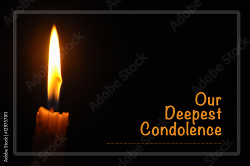 "Candle with flame in dark background. Our Deepest Condolences. A