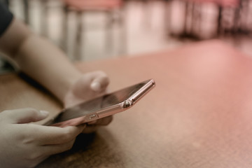 woman sitting at a table with a coffee using mobile phone.