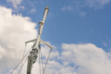 Obraz premium Grey mast on a blue sky with clouds