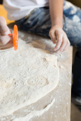 Close up of a father and his son preparing a cake in the kitchen