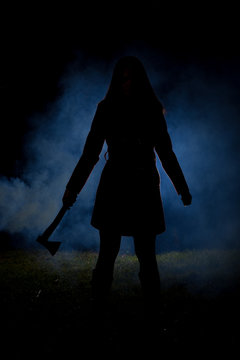 spooky silhouette girl at night with smoke in background