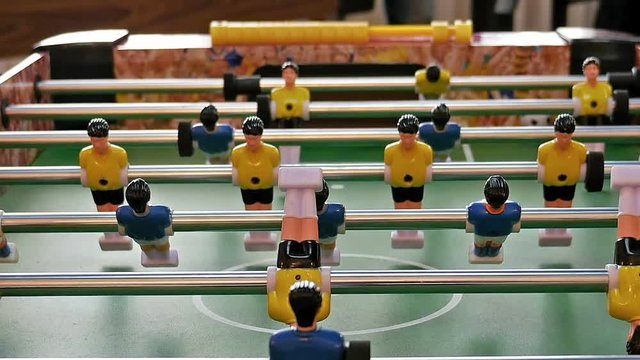 Father and child play kicker table football soccer. Baby-foot game.