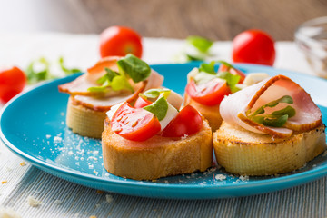Bruschetta with tomato, cheese and bacon
