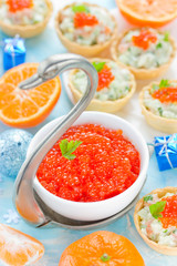 Festive Christmas table with refreshments - red caviar in a bowl