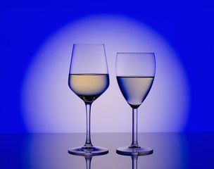 Wineglass with white wine on blurred blue  background