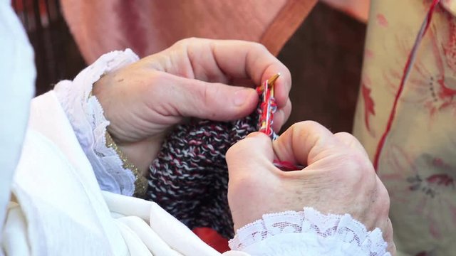 detail of hands and knitting needles