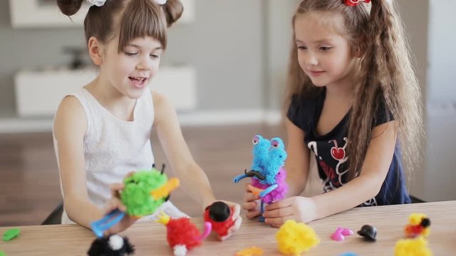 two pretty girls play with toys indoor