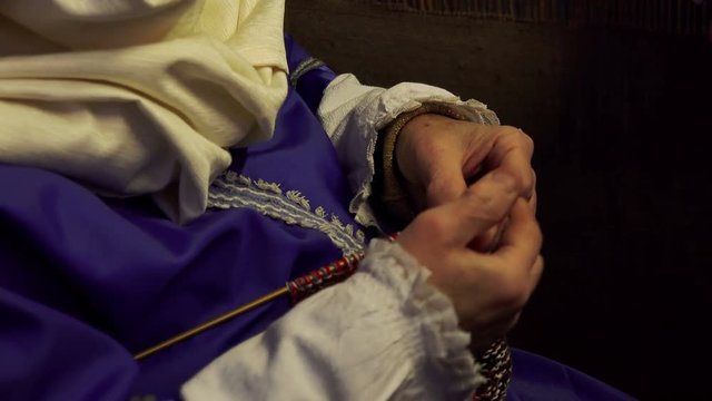 old woman knitting in the darkness