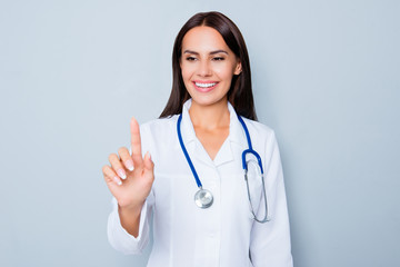 Female doctor in white uniform touching virtual screen