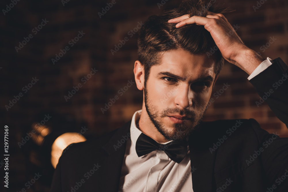 Wall mural Portrait of confident sexy businessman touching his hair