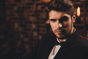 Portrait of young handsome elegant businessman in black suit
