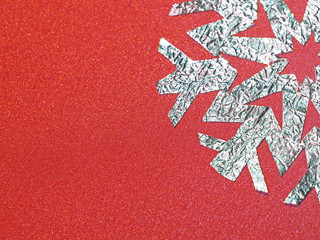 foil snowflake on a red background