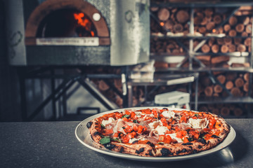 Fresh delicious pizza on white plate close-up