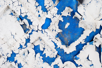 crumbling surface of old paint painted on a concrete surfaces