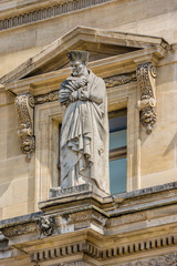 Fototapeta na wymiar Ancient sculpture on Louvre Museum building. Paris, France.