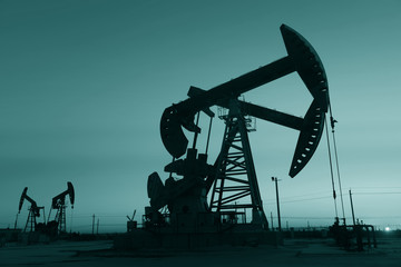 The beam pumping unit is homework, sunset in oil field