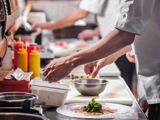 Chefs preparing food in the restaurant kitchen