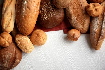 Fotobehang Variety of breads on a white table © Africa Studio