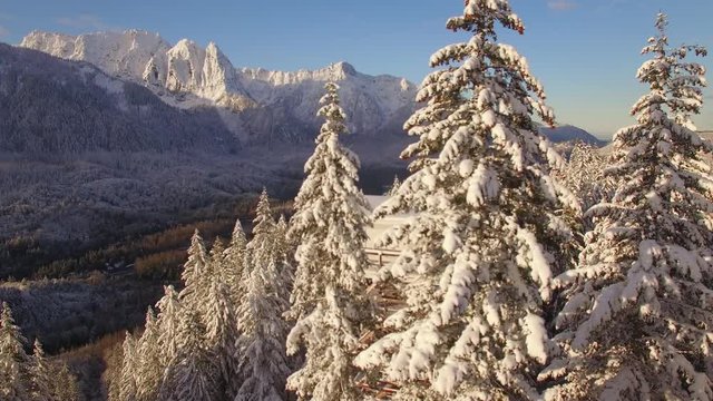 Drone Flying by Mountain Lookout View of Snow Covered Ridgeline with Jagged Peaks