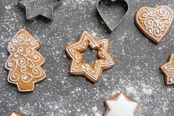 Delicious Christmas cookies with scattered powdered sugar on gray background