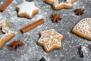 Delicious Christmas cookies with scattered powdered sugar on gray background