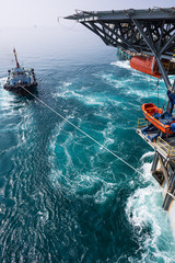 Boat towing jack up oil and gas rig