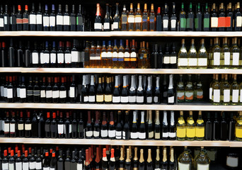 Shelves with alcohol bottles in supermarket
