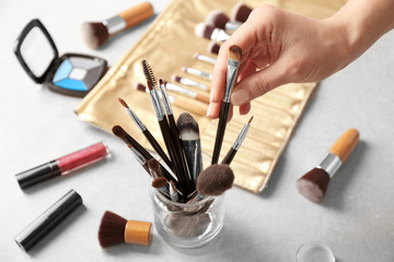 Female makeup artist hand with professional brush at work