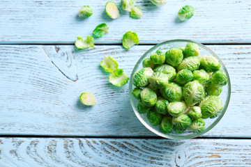 Brussels sprouts in glass bowl on wooden table
