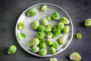 Metal tray with brussels sprouts on table