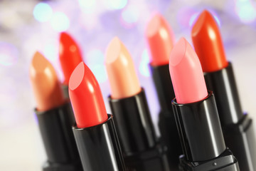 Obraz premium Collection of lipsticks on blurred lights background