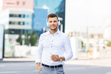 man with headphones and smartphone listening music