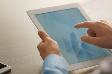 Businessman using tablet on table