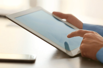 Businessman using tablet on table
