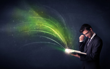 Young man holding book with wave