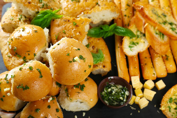 Tasty bakery products with garlic and herbs, close up view