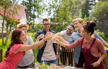 happy friends having party at summer garden