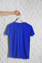 Blank blue t-shirt against light textured background